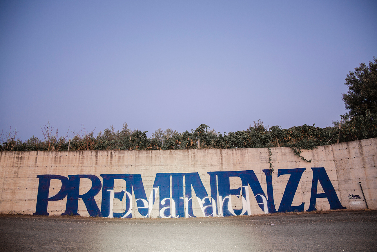 ''Preminenza della Parola'' Spray e quarzo su muro 14 x 2 m Nuoro 2021